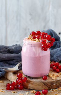 Close-up of strawberries in glass jar on table