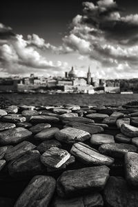 Stack of pebbles on beach against sky