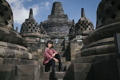 Full length of woman in temple outside building