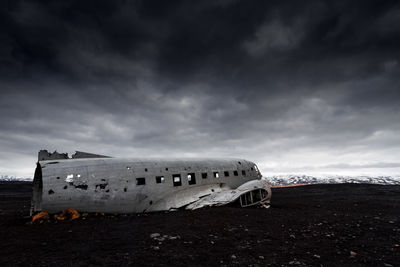 Crashed plane in basaltic desert of iceland dramatic scene