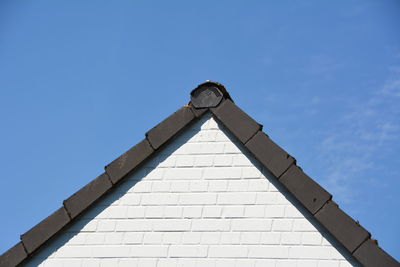 Low angle view of roof against blue sky