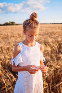 Cute girl standing on field