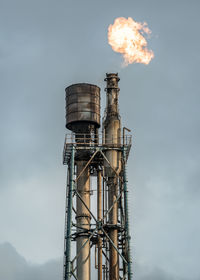 Low angle view of smoke stack against sky