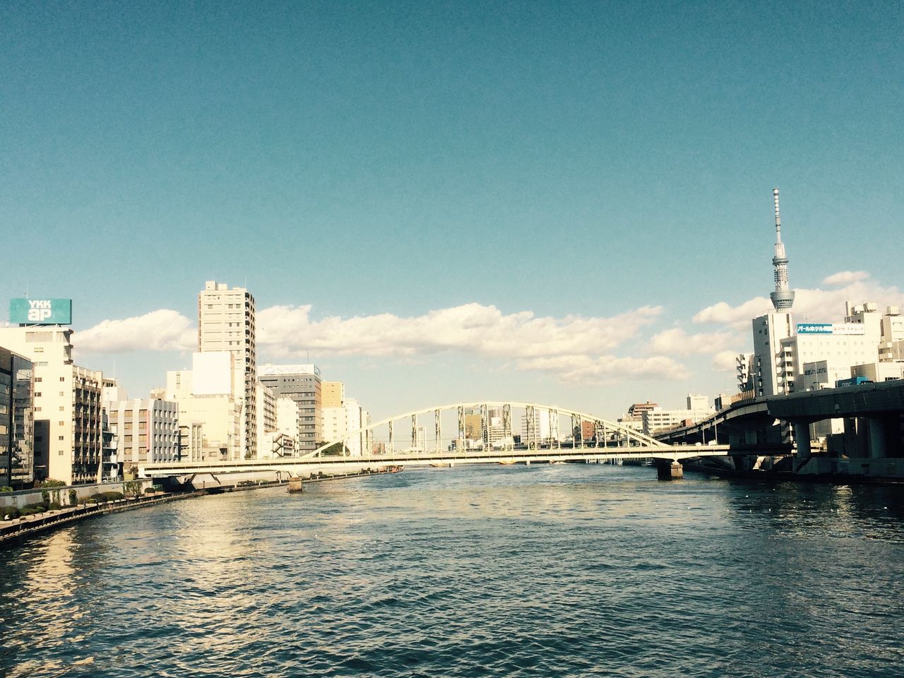 architecture, built structure, building exterior, water, waterfront, river, city, sky, tower, rippled, transportation, travel destinations, cityscape, day, capital cities, canal, connection, nautical vessel, no people, blue