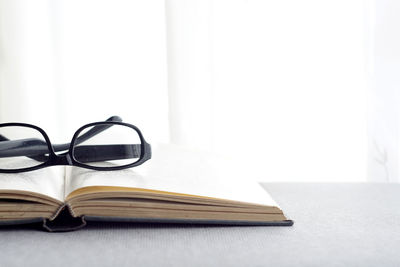 Close-up of eyeglasses on book