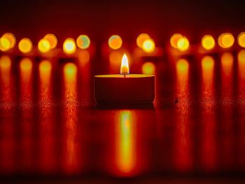 Burning tea light on flooring during diwali