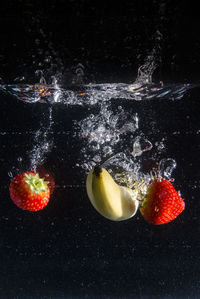 Close-up of bubbles in water against black background