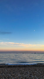 Scenic view of sea against sky at sunset