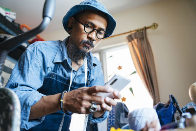 Man working over fabric on table