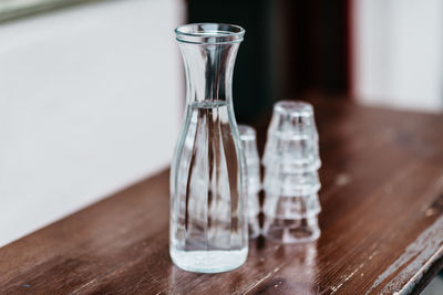 Close-up of glass bottle and shot glasses on table