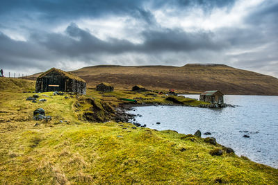 An old abandoned hamlet in the faroe islands. mountains and lake on background. high quality photo