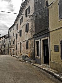 Street amidst buildings against sky in city