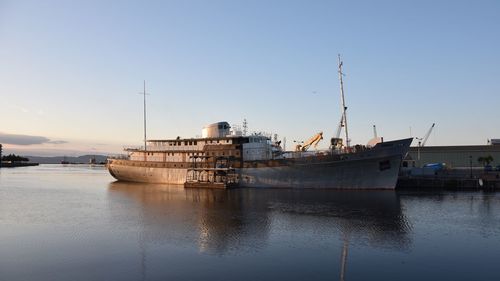 Ship on sea against clear sky during sunset