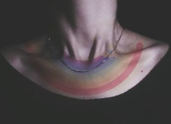 Close-up of person against black background