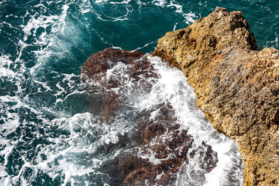 High angle view of rock formation in sea