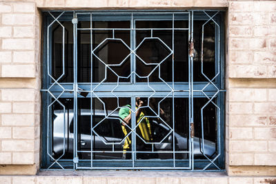 Man seen through glass window of building