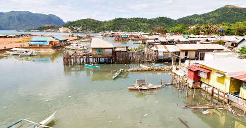High angle view of fishing boats moored by buildings