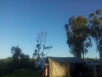 Low angle view of houses against clear blue sky