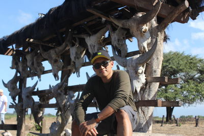 Portrait of young man standing against built structure