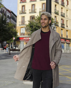 Fashion young model with grey jacket and in the street