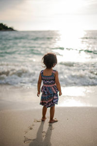 Rear view of girl on beach