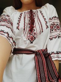 Midsection of woman standing against white background