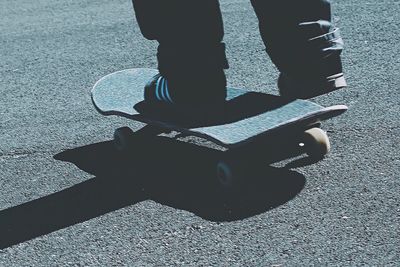 Low section of man standing on road