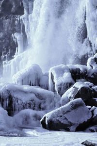 Scenic view of snow covered waterfall