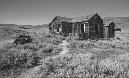 Abandoned building on field against sky