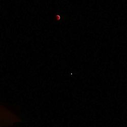 Low angle view of moon against sky at night