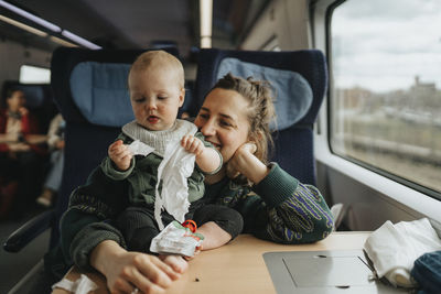 Woman traveling with baby by train