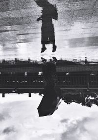 Reflection of woman in puddle