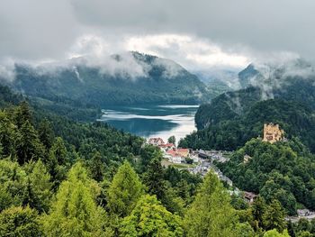 Scenic view of trees and mountains against sky