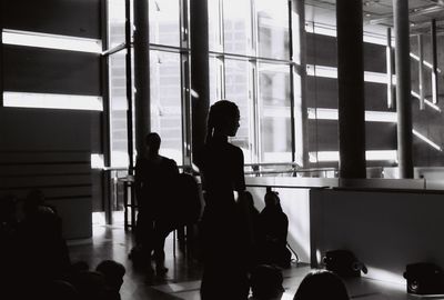 Silhouette people standing in front of building