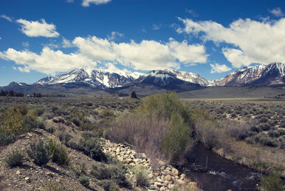 Scenic view of snowcapped mountains against cloudy sky