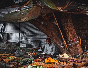 Full length of man standing at market stall