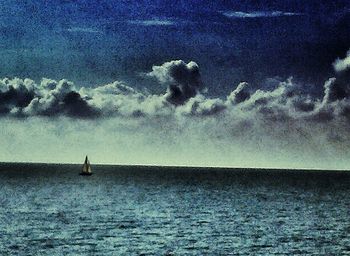 Scenic view of sea against cloudy sky