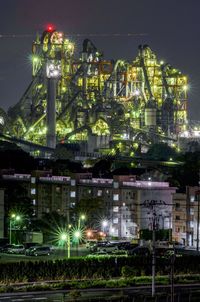 Illuminated industry against sky in city at night