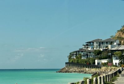 Building by sea against sky