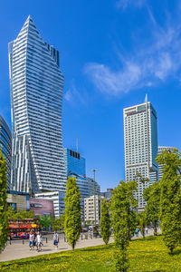 Buildings in city against blue sky