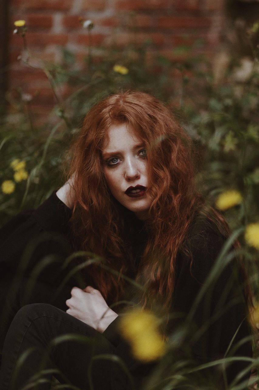 one person, young adult, portrait, young women, real people, leisure activity, looking at camera, lifestyles, front view, redhead, beauty, adult, beautiful woman, land, women, plant, selective focus, looking, hairstyle, hair, outdoors, contemplation