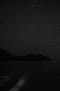 Scenic view of lake against sky at night