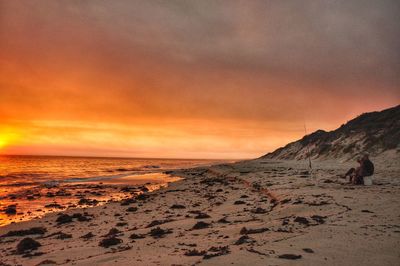 Scenic view of beach against sky during sunset