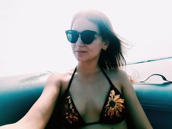 Close-up of young woman wearing sunglasses against sky