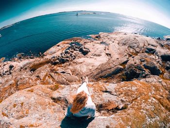 High angle view of woman by sea against sky