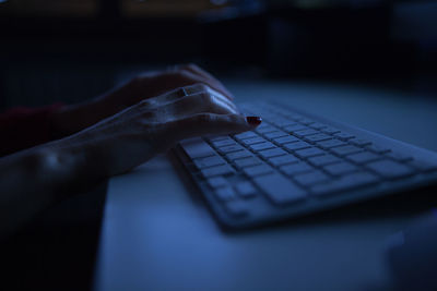 Close-up of woman using keyboard