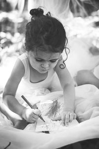 Rear view of girl with arms raised on paper