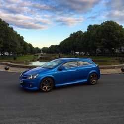 Side view of cars parked on road