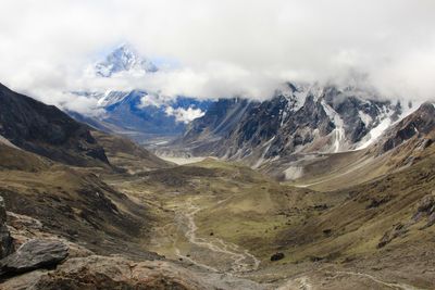 Scenic view of mountains against cloudy sky