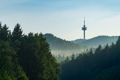 Scenic view of trees and mountains against sky